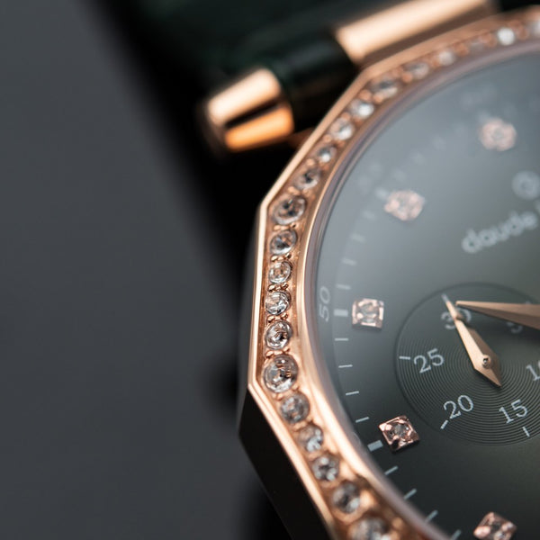 Close crop of a rose gold bezel set with stones