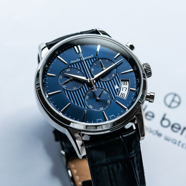 A blue guilloche chronograph dial photographed close up